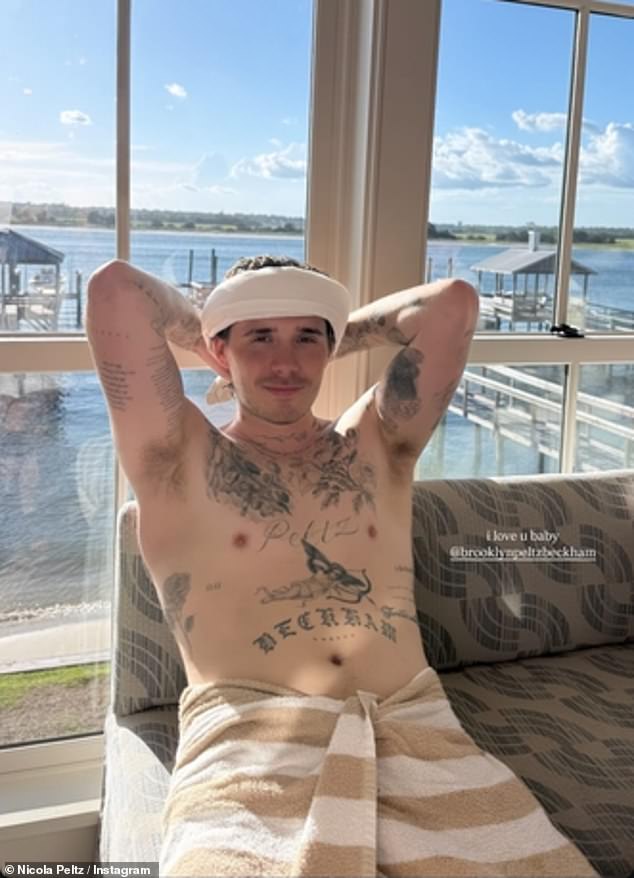 She also shared a shirtless photo of her hunky husband Brooklyn Beckham, 26, as he posed in nothing but a towel