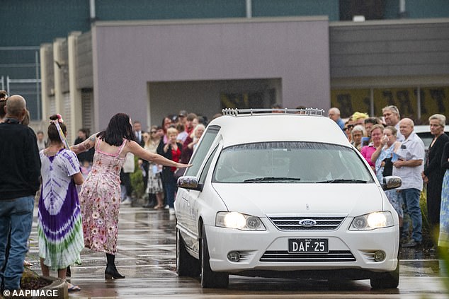 As the hearse drove by Ms Johnson reached out to touch her daughter