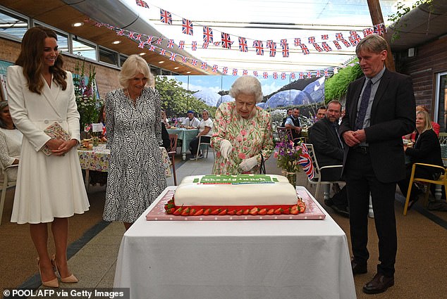 When an aide helpfully suggests she could use a standard knife to slice the cake, Queen Elizabeth II joked: 'I know there is. This is more unusual'