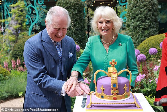 King Charles and Queen Camilla pictured laughing as they cut a cake during a visit to open the new Coronation Garden on their two-day visit to Northern Ireland