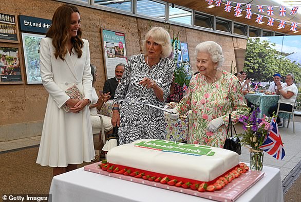 Queen Elizabeth employs a sword - to general amusement on June 11, 2021 in St Austell, Cornwall