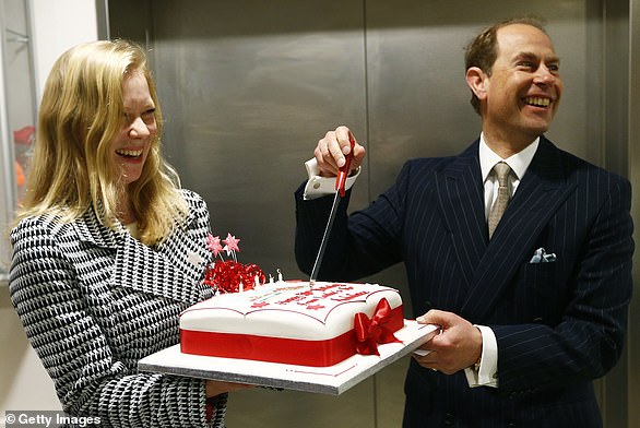 Prince Edward knows the form as he cheerfully cuts birthday cake during a visit to the London Air Ambulance at the Royal London Hospital on March 10, 2014