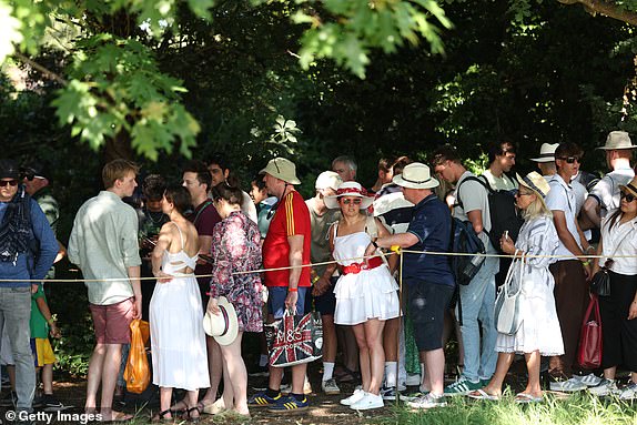 LONDON, ENGLAND - JUNE 30: Spectators queue on day one of The Championships Wimbledon 2025 at All England Lawn Tennis and Croquet Club on June 30, 2025 in London, England. (Photo by Ezra Shaw/Getty Images)