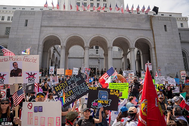 Demonstrators march through downtown during a 'No Kings' protest in Los Angeles, California