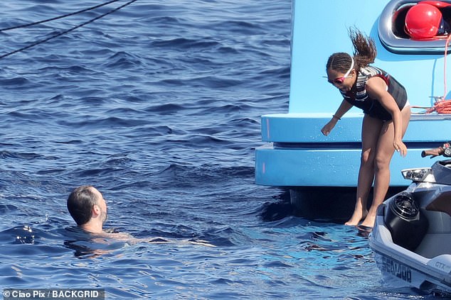Dad Alexis paddled in the water as their eldest daughter Olympia, jumped off the yacht
