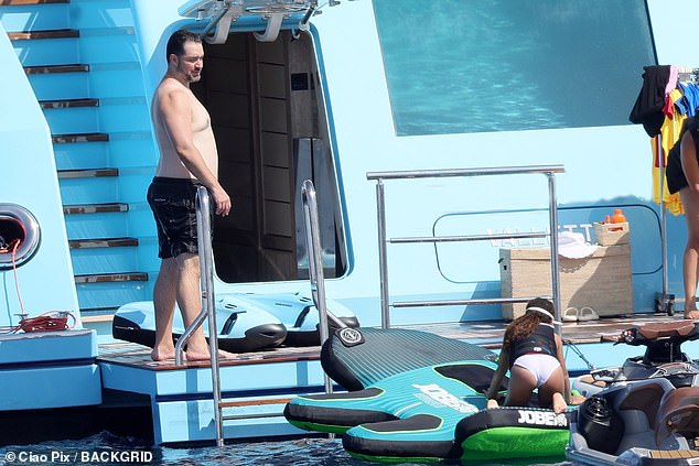 Alexis watches on as Olympia jumps on an inflatable to be dragged around by a jetski