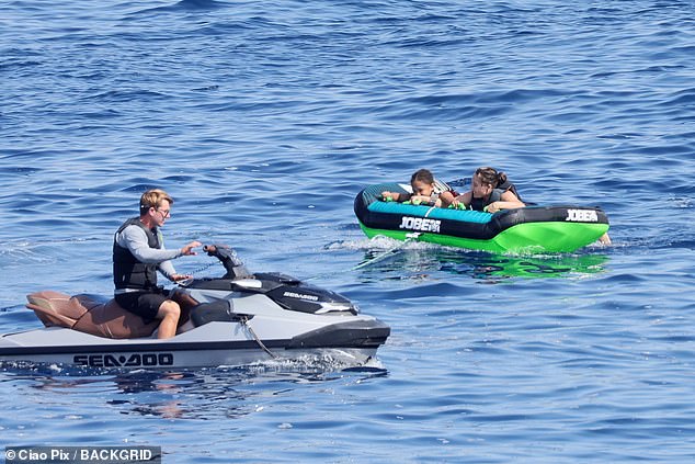 The young family enjoyed some watersports during their vacation in Sardinia, Italy