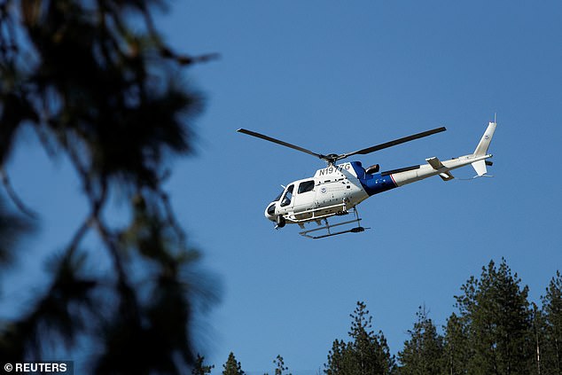 A United States Customs and Border Protection helicopter lifts off from Cherry Hill Park after multiple firefighters were attacked when responding to a fire in the Canfield Mountain area