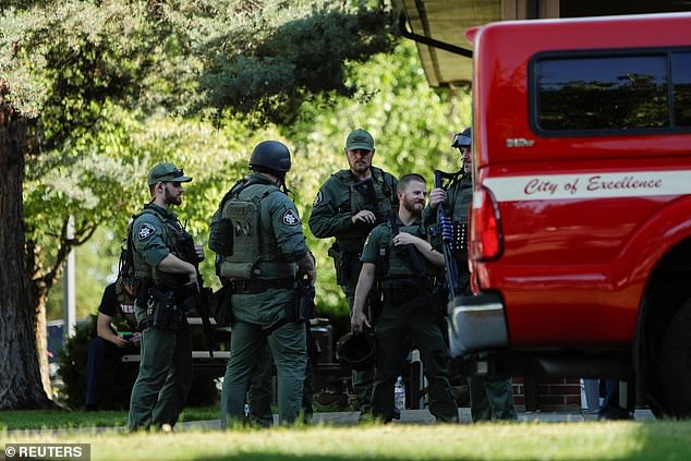 Law enforcement officers gather at Cherry Hill Park after multiple firefighters were attacked