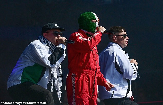 The force said it was also probing footage and audio of a performance by Irish-language rap trio Kneecap. Pictured: Their performance at Glastonbury