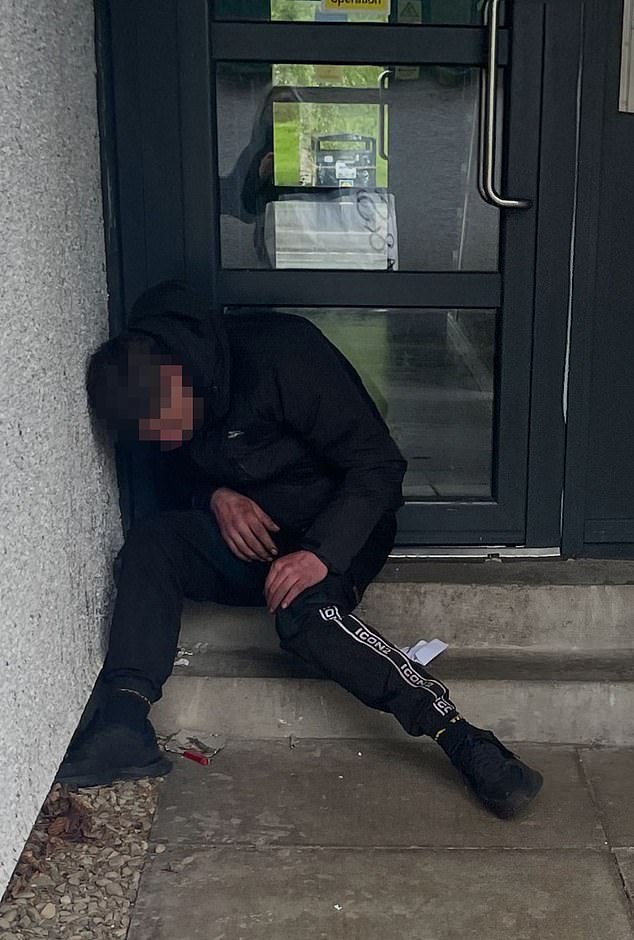 A drug userlies hopelessly slumped in a doorway in an area near the new facility