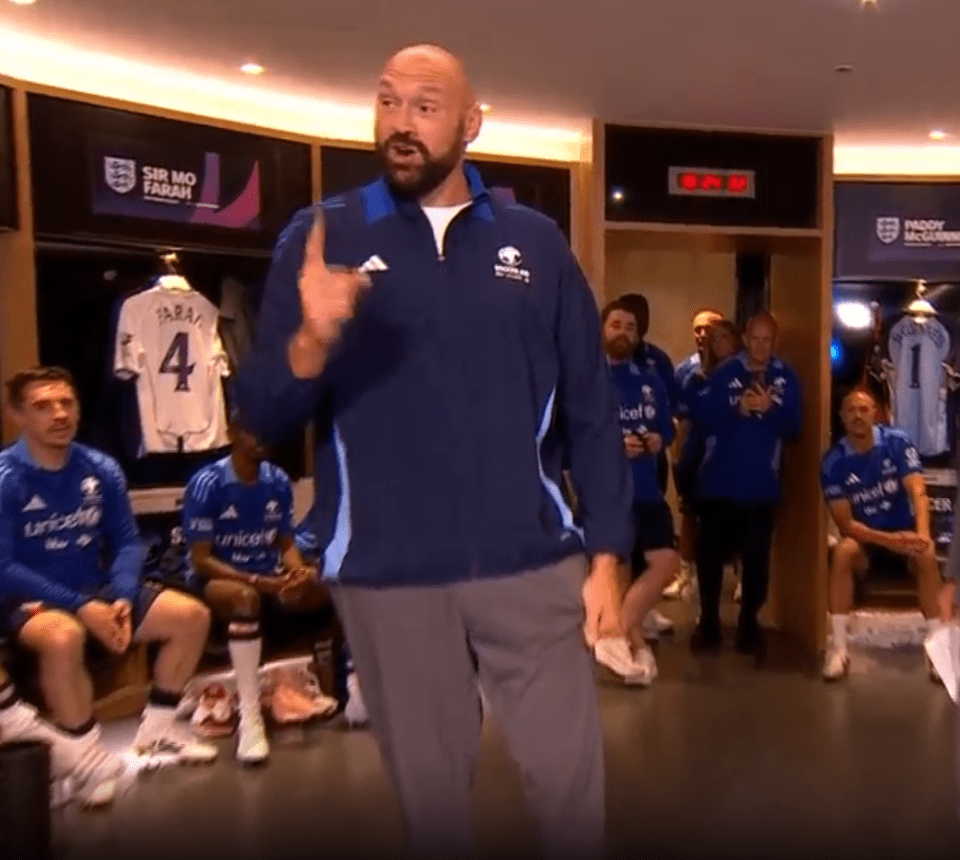 Tyson Fury addressing a rugby team in a locker room.
