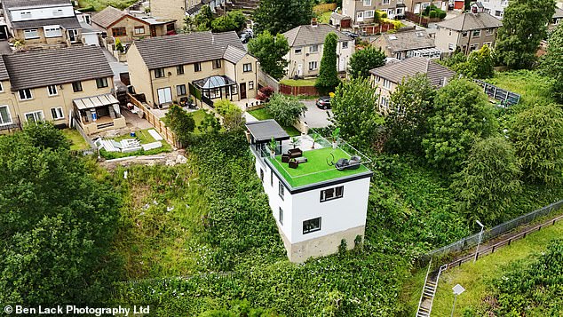 A builder who created a spectacular Grand Designs-style pad carved into a steep railway embankment has been ordered to tear it down