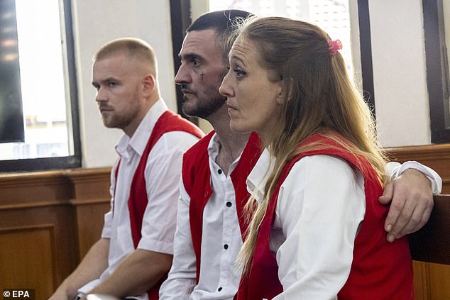 Jon Collyer, 38, was pictured with his arm around his partner Lisa Stocker, 39, in court today. Pictured right is their co-defendant Phineas Float