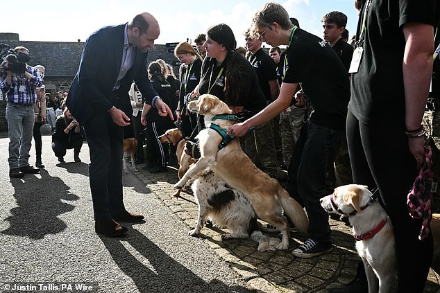 Prince William is greeted by a dog at Duchy College Stoke Climsland in Callington, Cornwall, on October 17 last year during a visit to learn about the college helping young people in rural areas