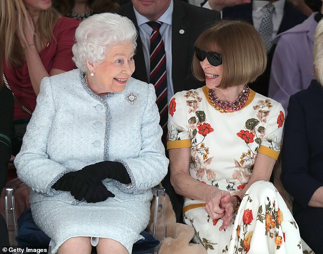 Anna Wintour sits next to Queen Elizabeth II as they viewed Richard Quinn's runway show before presenting him with the inaugural Queen Elizabeth II Award for British Design in February 2018