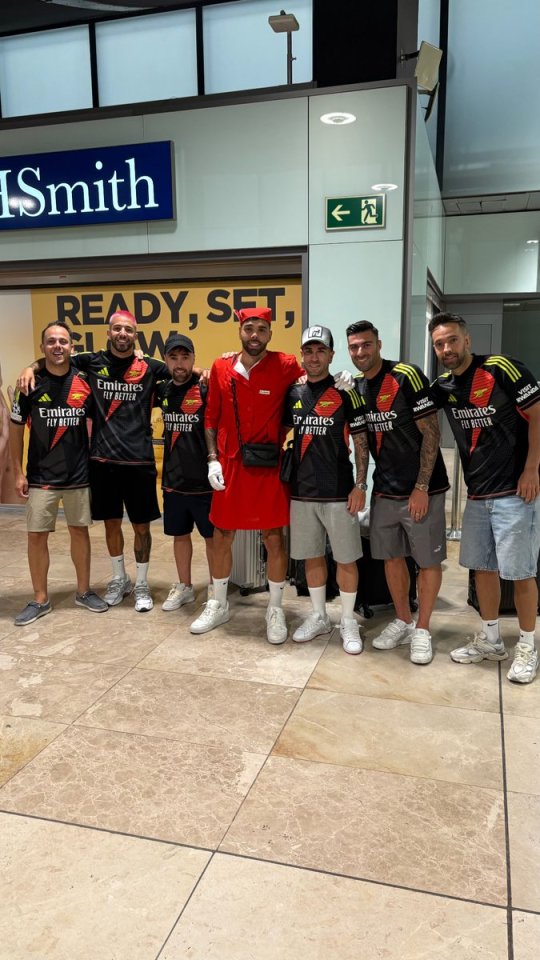 Group photo of men in Arsenal jerseys.