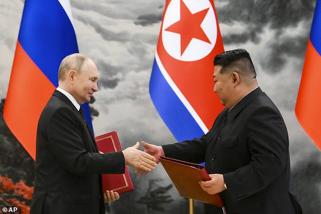 Pictured: Vladimir Putin (left) and North Korea's leader Kim Jong Un (right) during a signing ceremony of the new partnership in Pyongyang, North Korea, on June 19, 2024