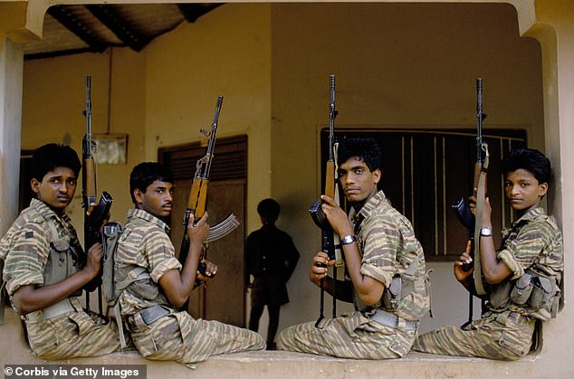 An asylum seeker who allegedly recruited child soldiers for the Tamil Tigers terrorist group has won an appeal (pictured: Tamil Tigers fighters in a stock photo)