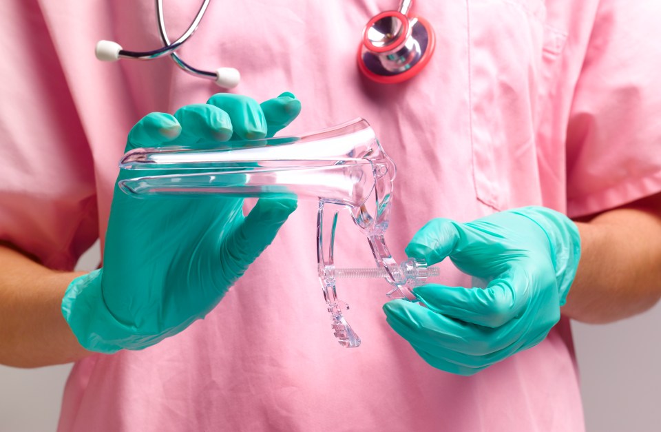 Gynecologist holding a vaginal speculum.