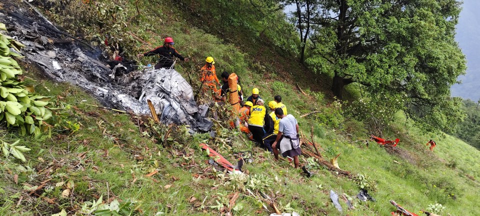 Rescue workers at a helicopter crash site.