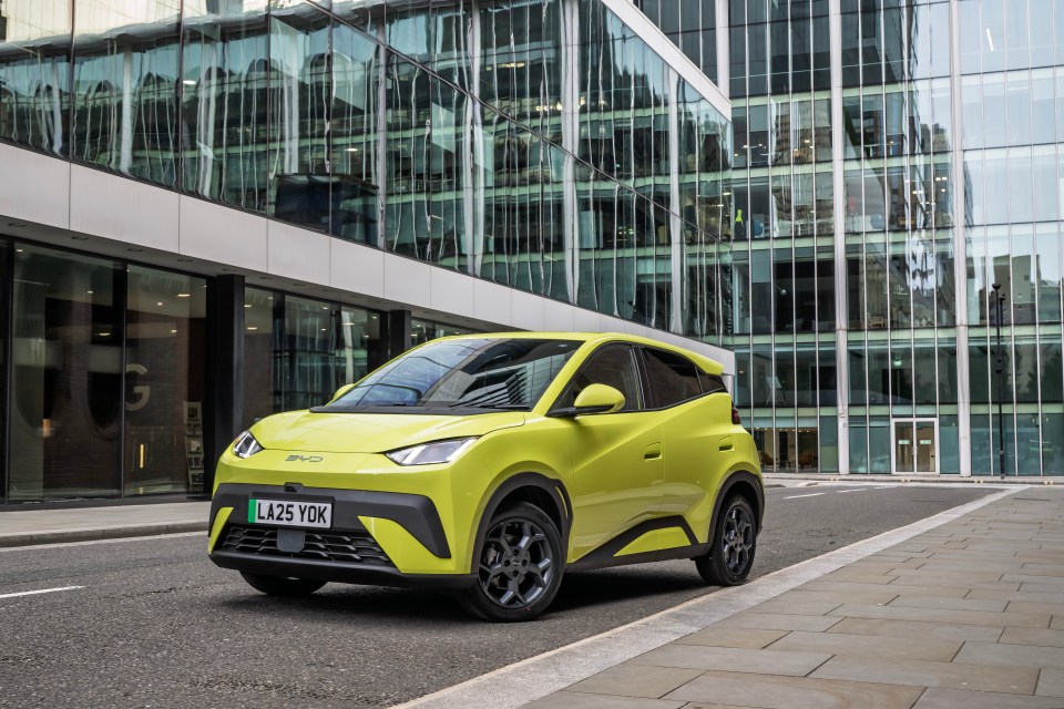 Lime green electric car parked on city street.