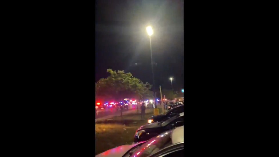 Nighttime scene of emergency vehicles at a Salt Lake City shooting.