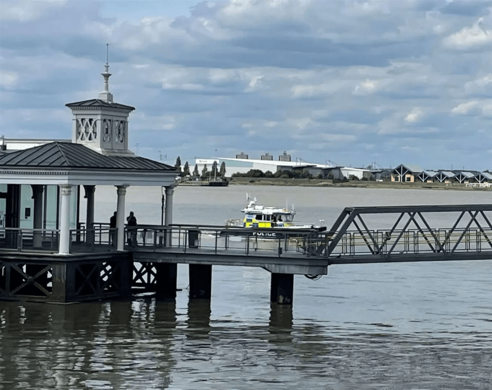 Police boat approaching a pier.