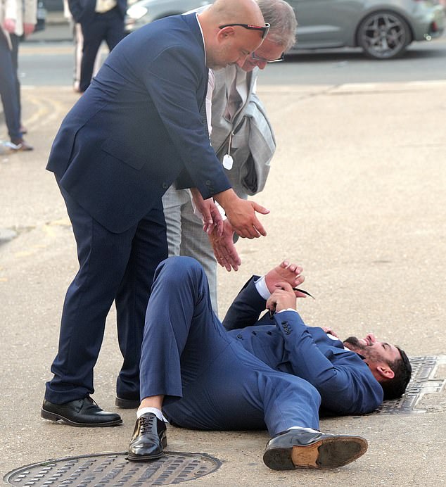 One suited Royal Ascot reveller takes a stop on the kerb to rest after a long day of drinking in the sun