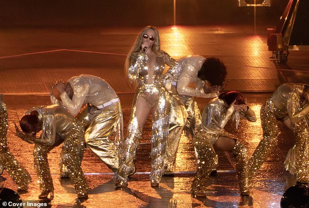 The mother-of-three wore a gold plunging bodysuit under gold fringed chaps with high heels, accessorising with a pair of sunglasses