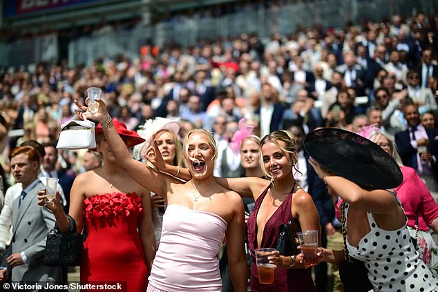 Cheers! Revellers wasted no time and enjoyed pints from the sidelines