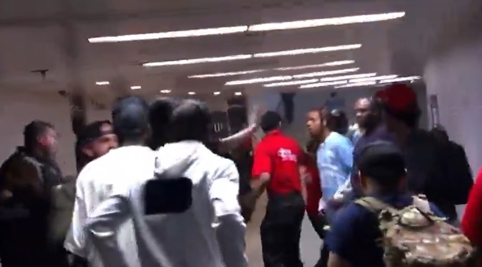 Boxer Keyshawn Davis escorted by police after a backstage brawl.