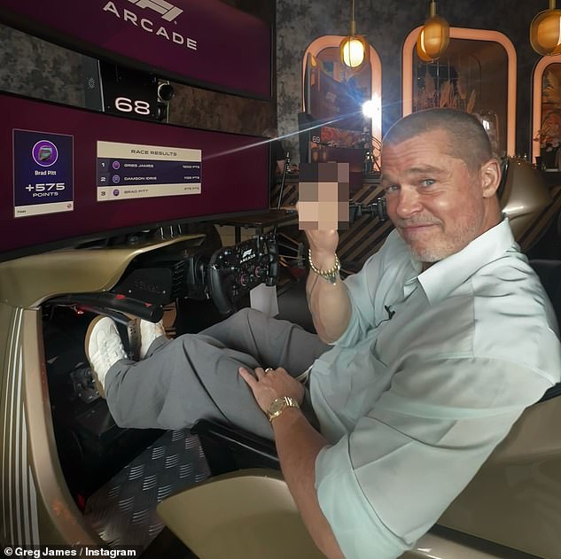 Brad Pitt offered up his middle finger for a photo after being embarrassed by the BBC's Greg James at a Formula 1 simulator in London