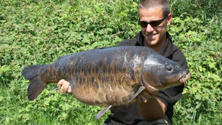 Man holding a large carp.
