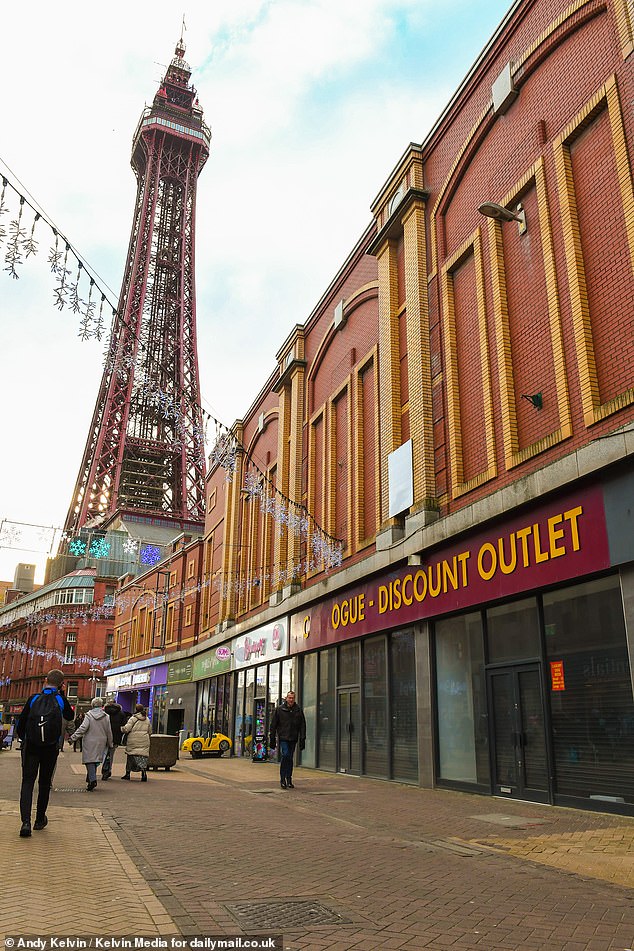 Locals walk past derelict shops in Blackpool, December 2024
