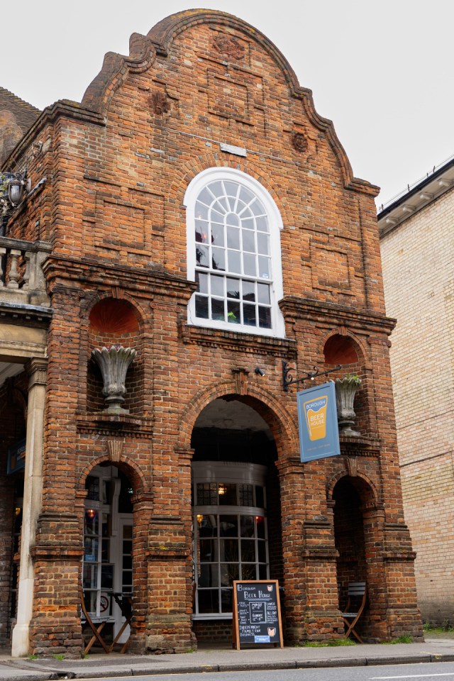 Brick building with arched entrance and windows, Borough Beer House sign.
