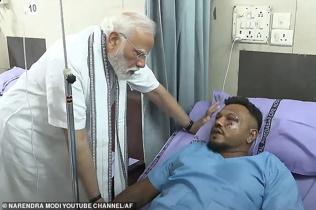 Briton Vishwash Kumar Ramesh, 40, miraculously survived the plane disaster. Pictured: Prime Minister Narendra Modi (L) meeting with Vishwash Kumar Ramesh in an Ahmedabad hospital on Friday