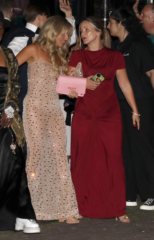 Two women in formal wear at an awards ceremony.
