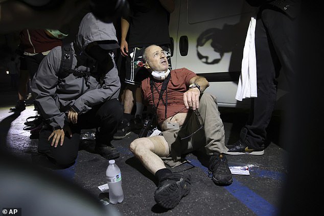 Nick Stern (above) had been snapping images of a stand-off between protestors and armed police in the Californian city when a 14mm 'sponge bullet' pierced his thigh