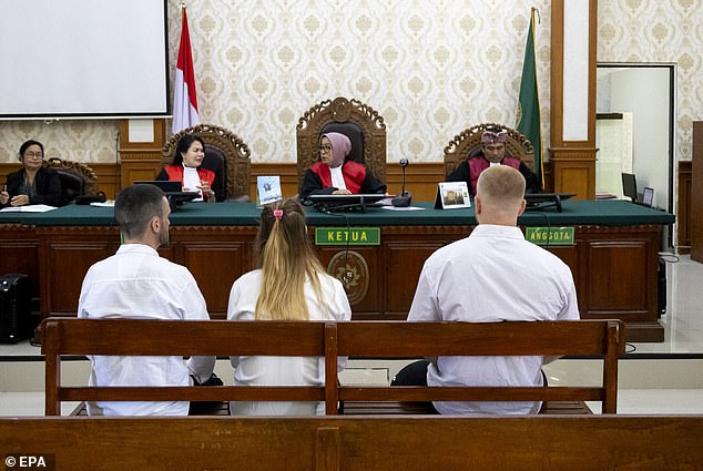The group were pictured listening to a judge during their court appearance today