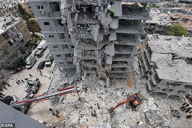 Britons have been warned not to travel to Israel as the conflict with Iran ramps up today (pictured, wreckage in Bat Yam, central Israel today)