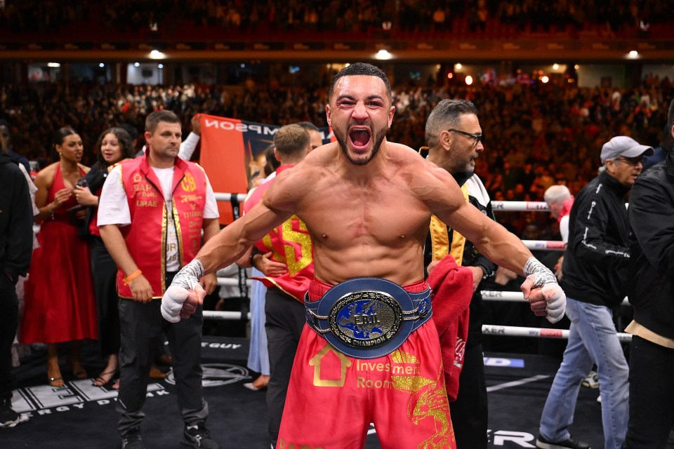 Boxer Callum Simpson celebrates victory with his EBU European Super Middleweight title belt.