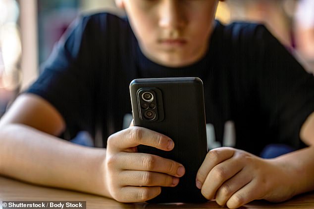 Children could face a lifetime ban from social media if they share a classmates' nudes, under new proposals (Stock Photo)