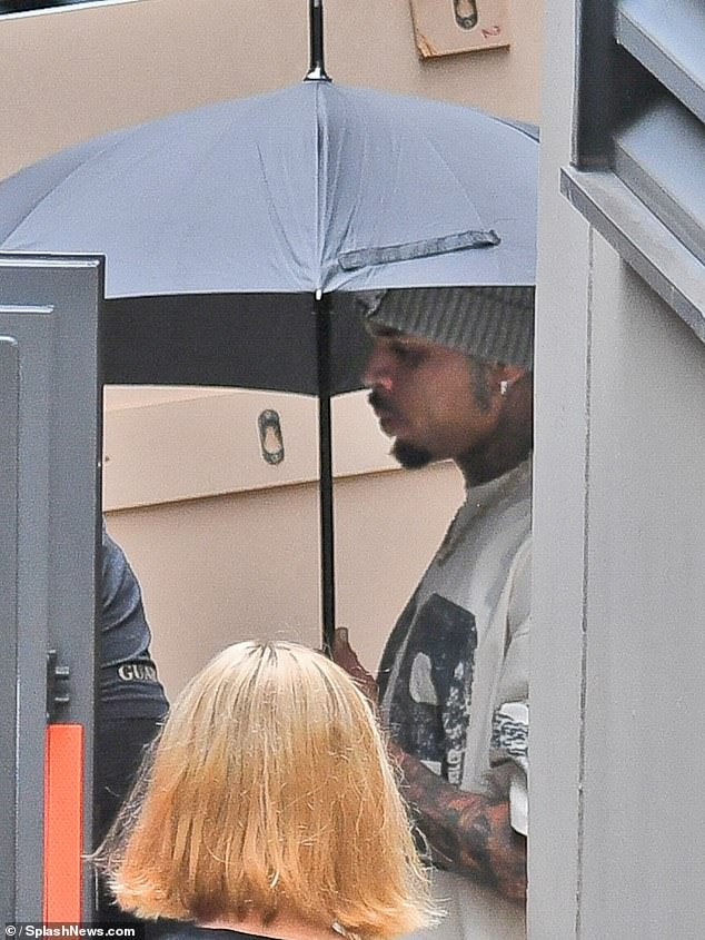 Chris Brown, 36, hid his face as he returned to perform in Manchester on Sunday, a month after being arrested in the city over an alleged nightclub bottle attack