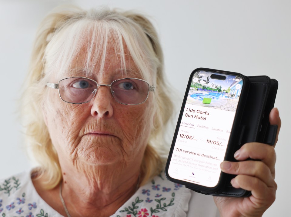 Woman showing her phone screen with a Corfu hotel booking.