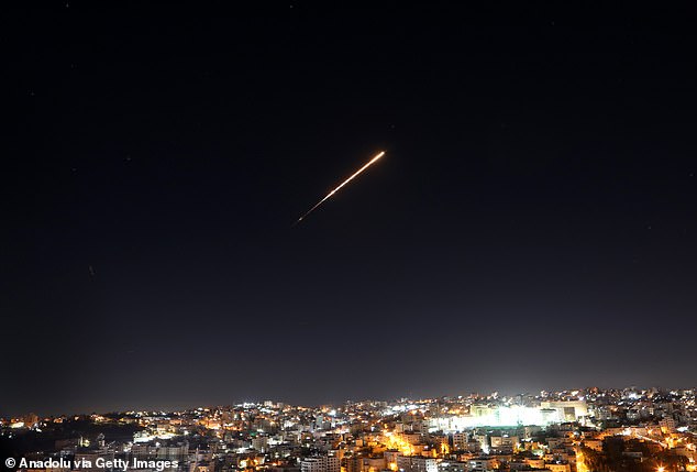 Missiles fired from Iran are seen streaking across the skies over the city of Hebron in the West Bank on Wednesday as insiders tell DailyMail.com that Israel's bombardment has the regime on the back foot of their conflict