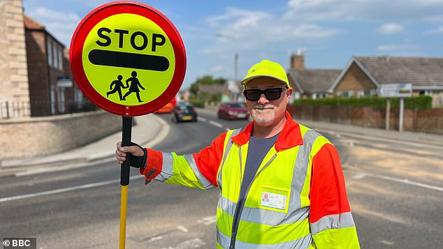 Neil Cotton, 57, has spent the last two years brightening up the school run in the East Yorkshire town of Howden with his cheerful attitude and signature high fives