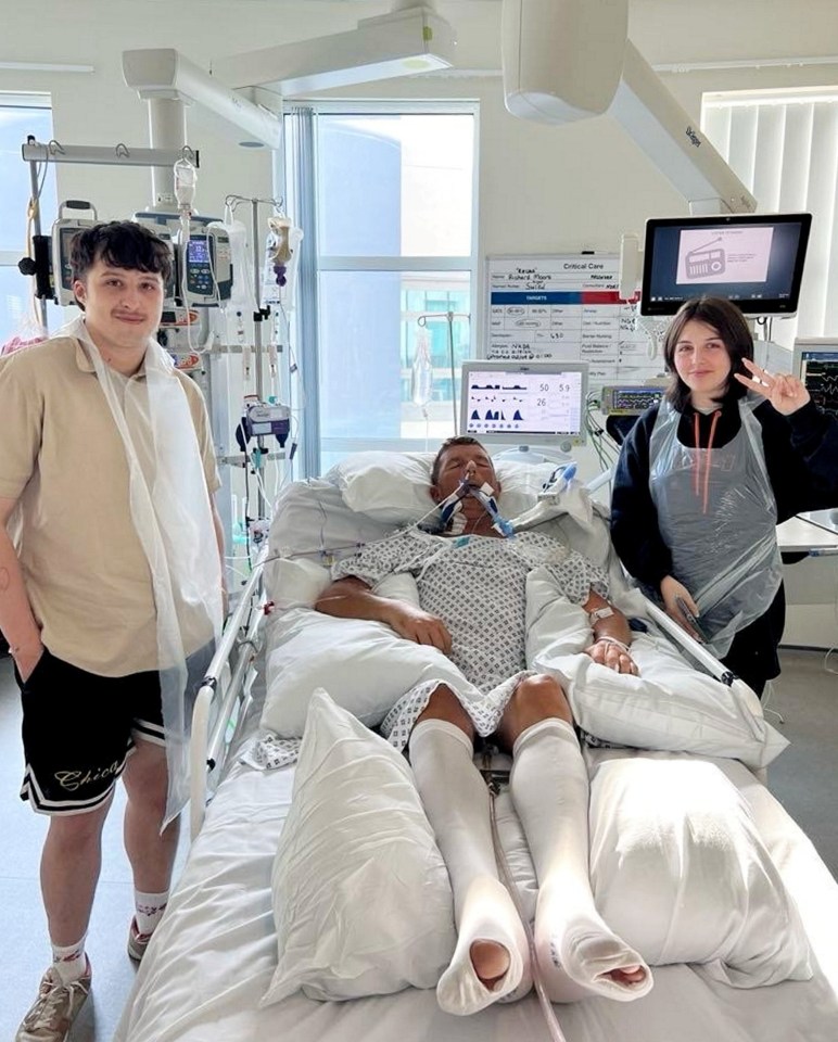 A father in a hospital bed with his two children.