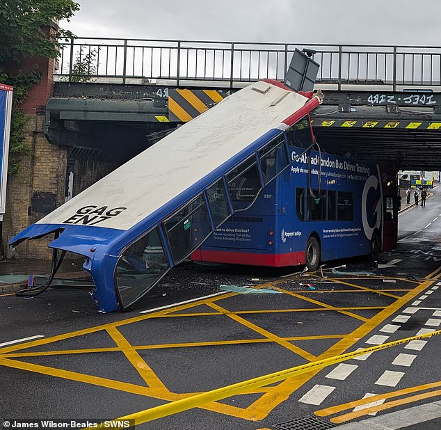 A trainee double-decker bus had its roof ripped off when it crashed into a London railway bridge. The training bus, which was carrying no passengers on board, hit the Norwood Junction railway bridge in South London shortly after midday on Thursday