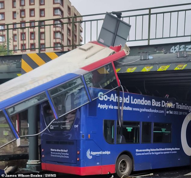 Dramatic images of the training bus show debris lining the street as the entire roof of the bus hangs nearly horizontally from the 12ft high bridge down to the road. Meanwhile, a nearby sign reads: 'Warning to buses - low bridge ahead'